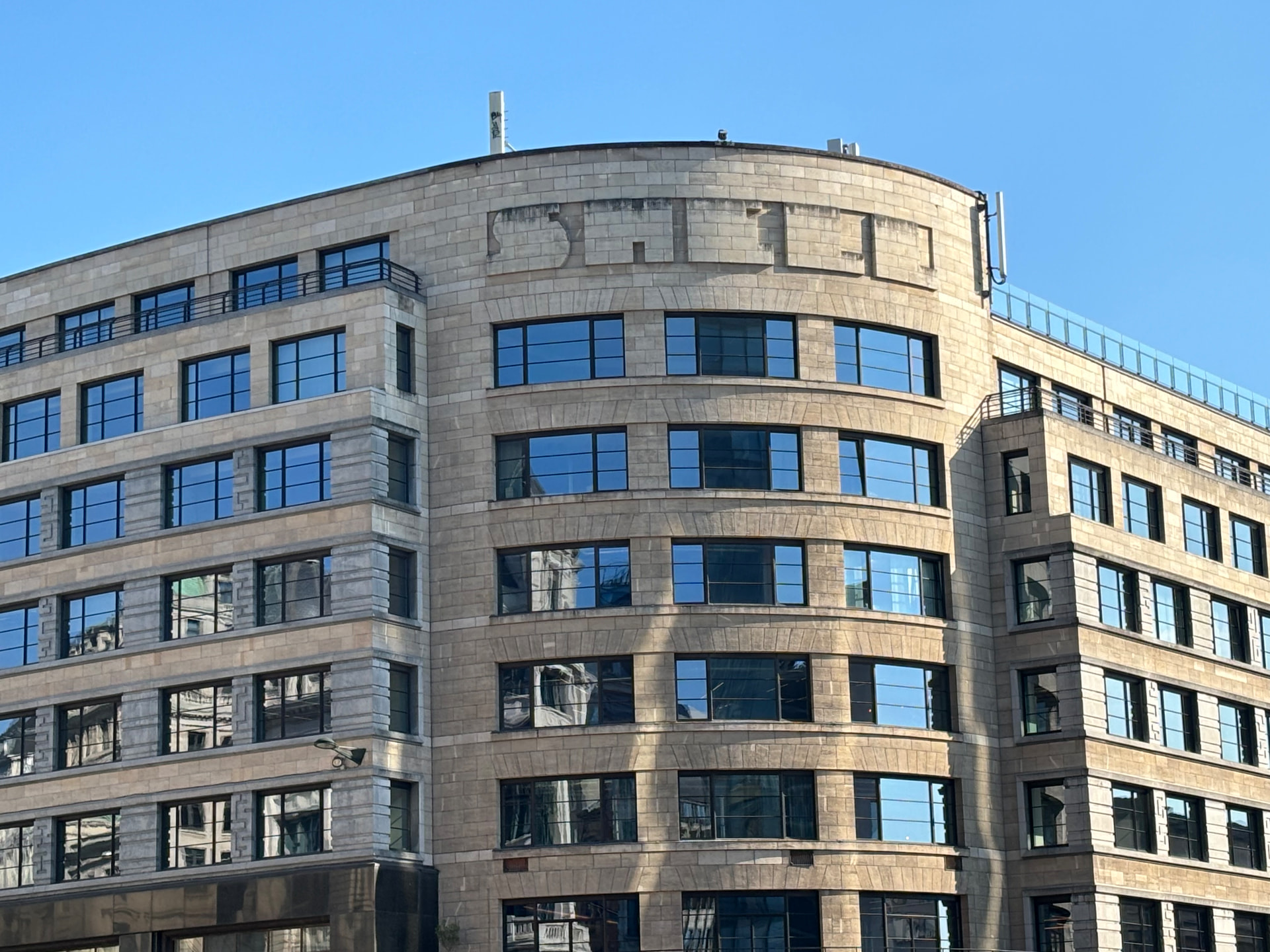 Facade of Central Gate, the former Shell building in Brussels, the SHELL inscription still visible in relief on the stone, blue sky